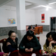 Zhao and Wang drink tea as Wang’s family play cards.